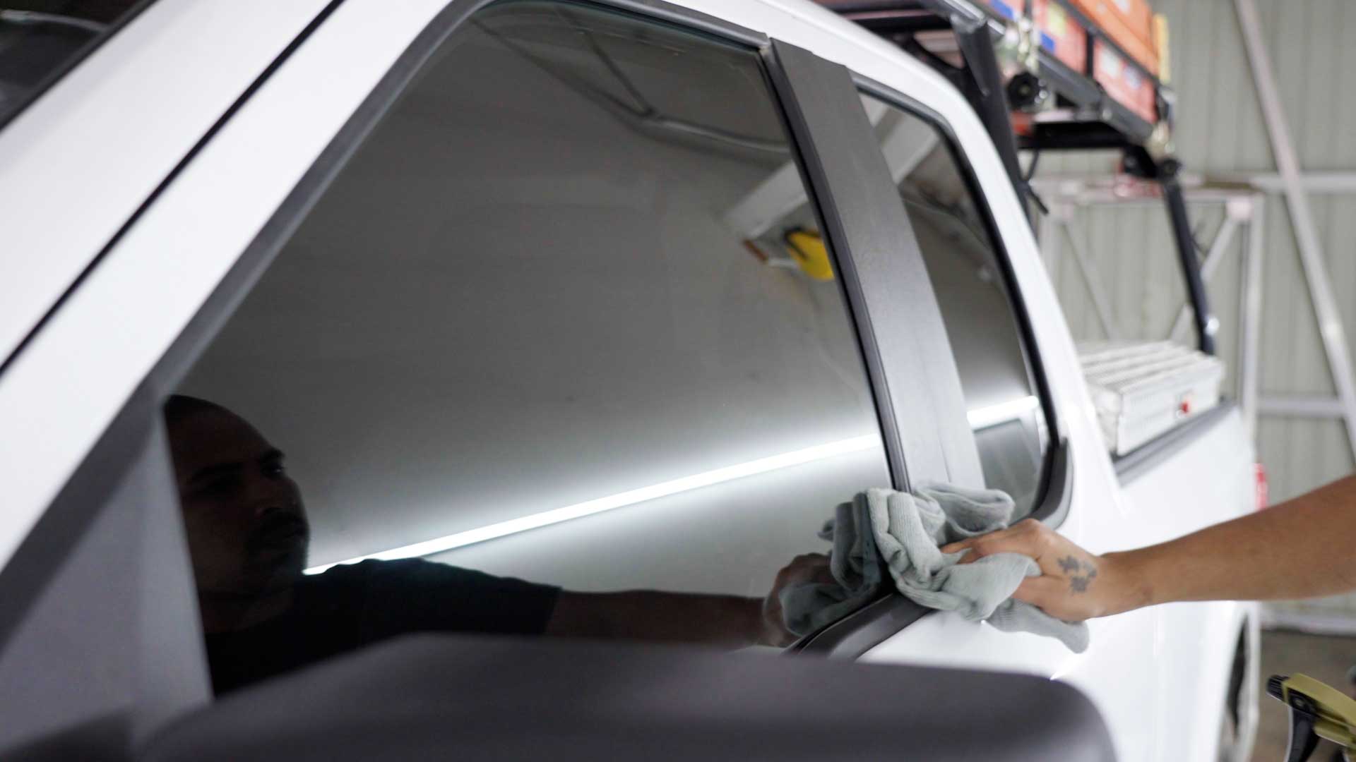 Professional Electric Vehicle Glass Tint being cleaned after tinting in Sheboygan