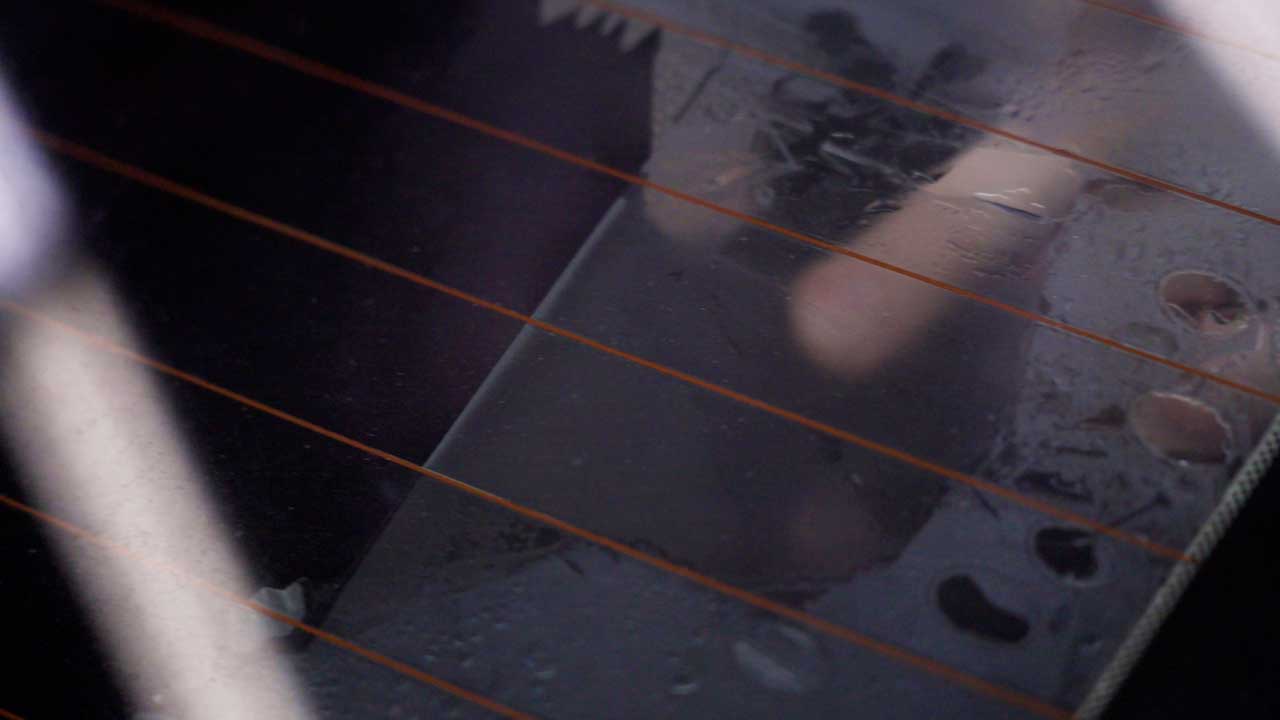 Professional removing window film to comply with Arkansas tint laws