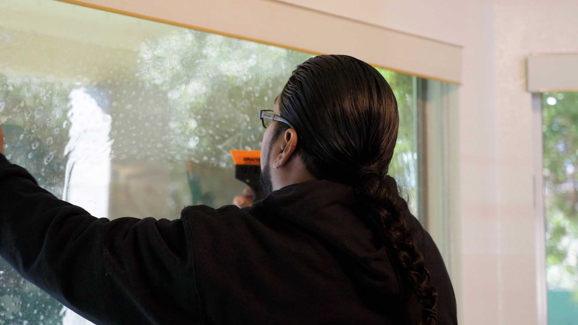 Kepler Installer Applying Security Window Film to a Building in Illinois