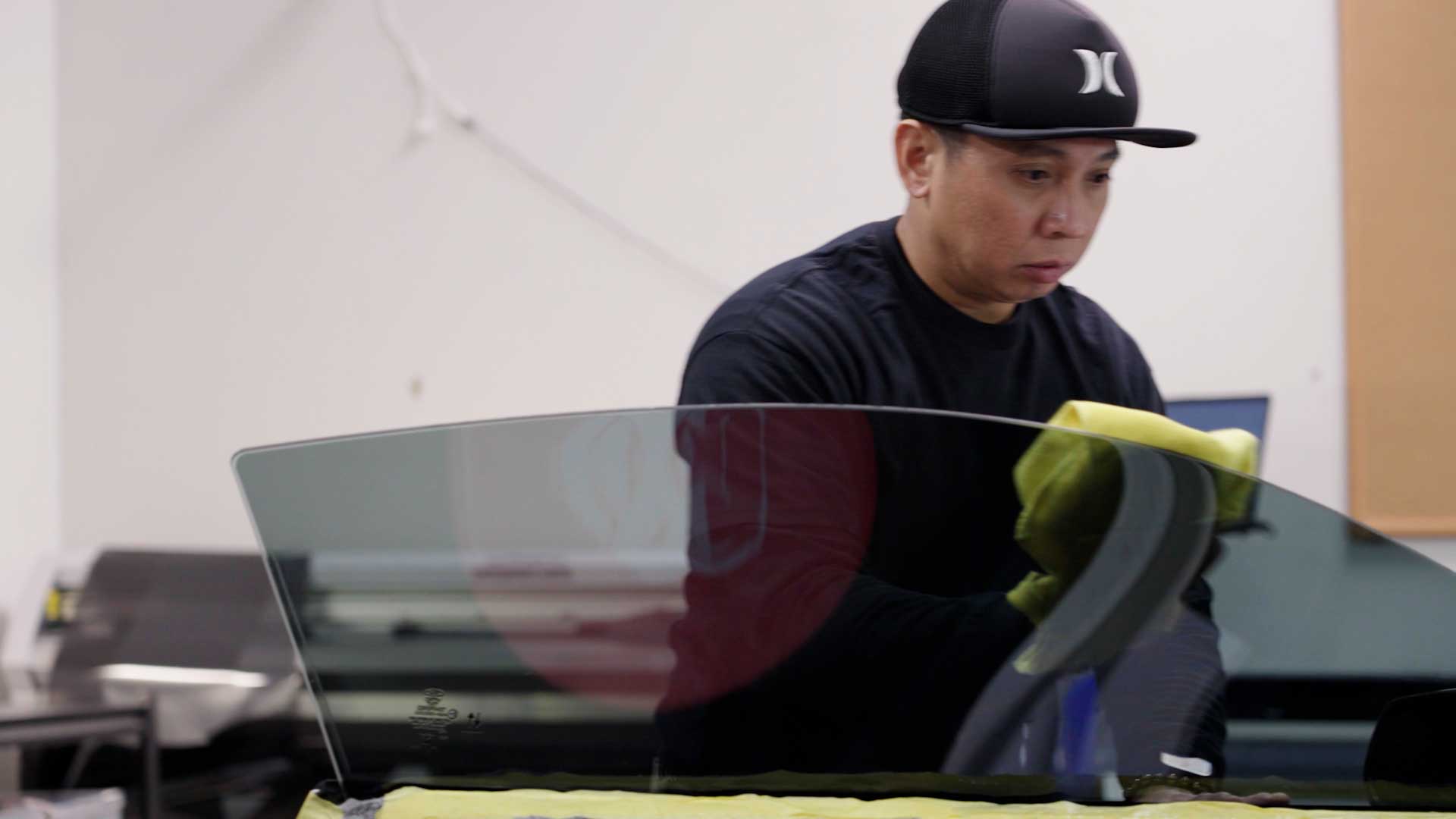 Skilled Tesla Window Tinting being cleaned after tinting in Islip