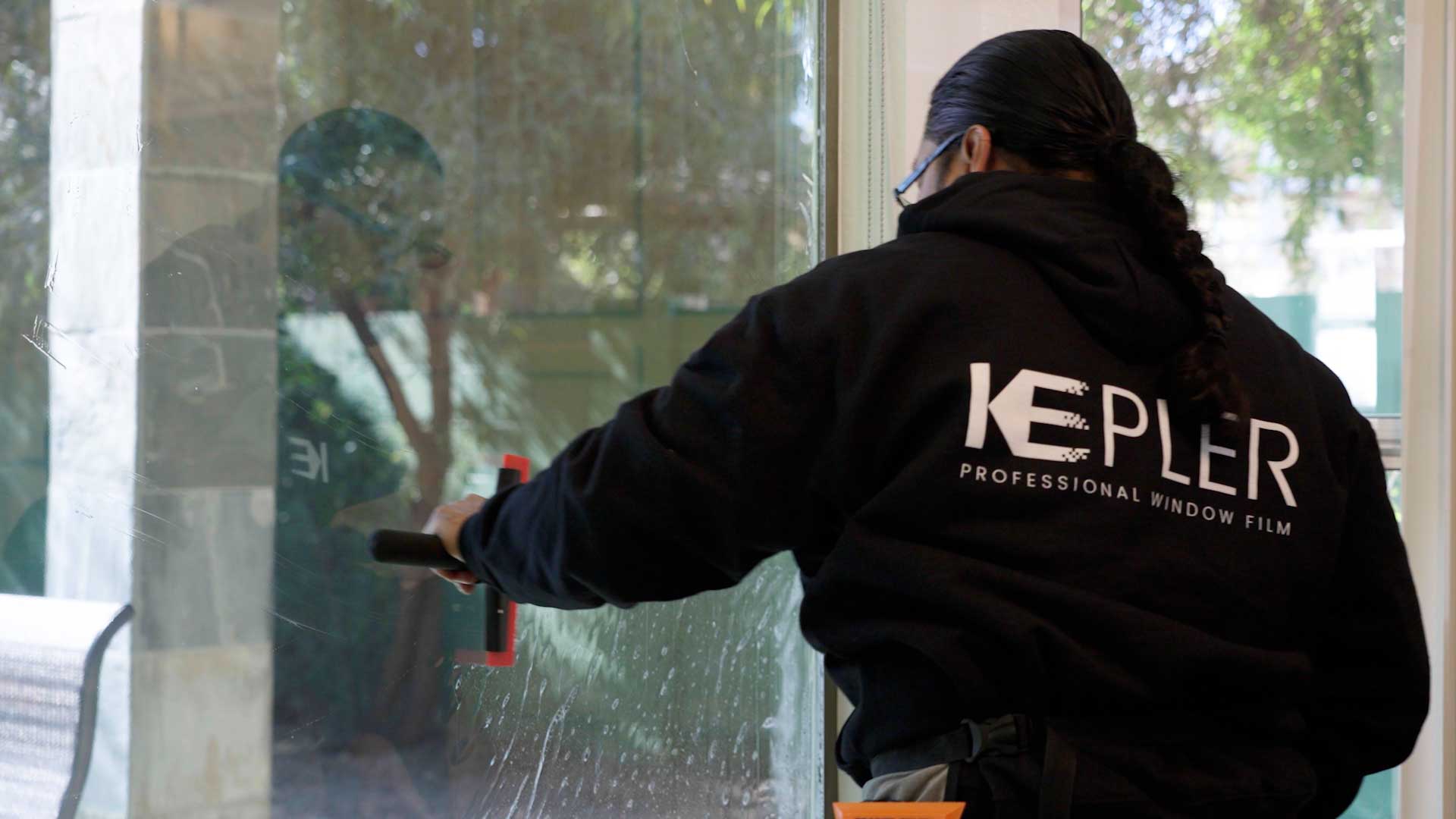 Kepler Installer Applying Security Window Film to a Building in North Dakota