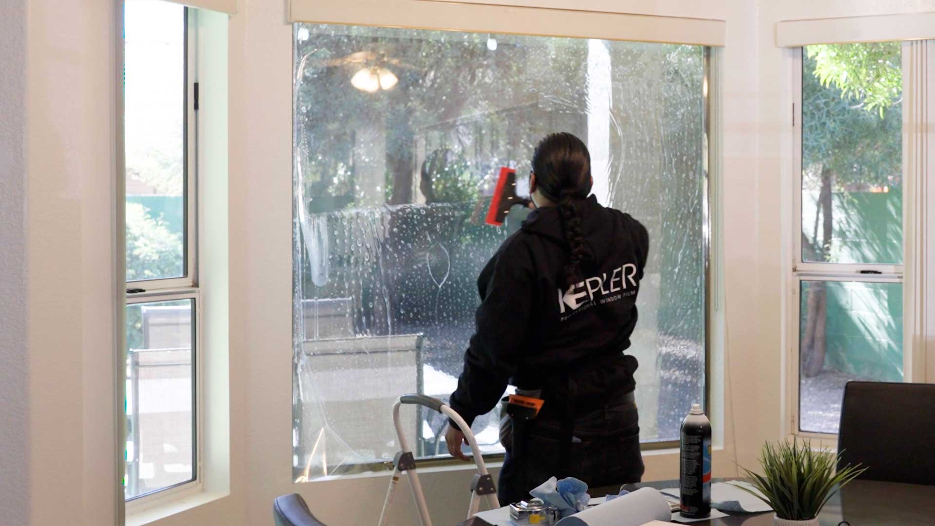 Kepler Installer Applying Security Window Film to a Building in Iowa