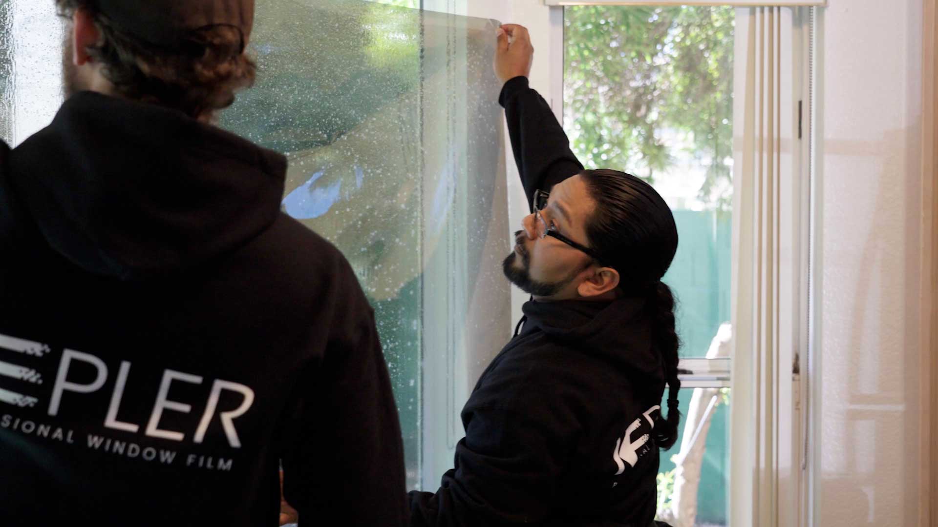 Kepler Installer Applying Security Window Film to a Building in New Jersey