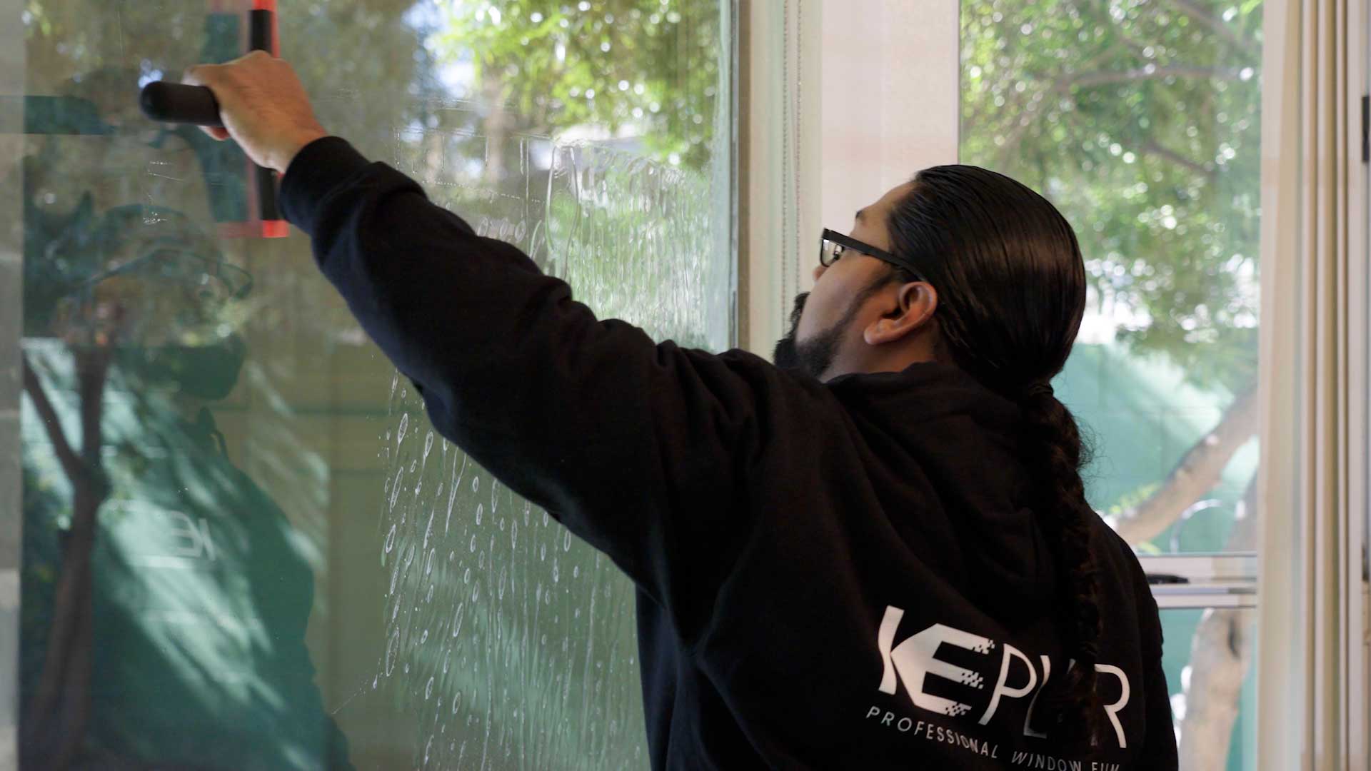 Kepler Installer Applying Security Window Film to a Building in Connecticut