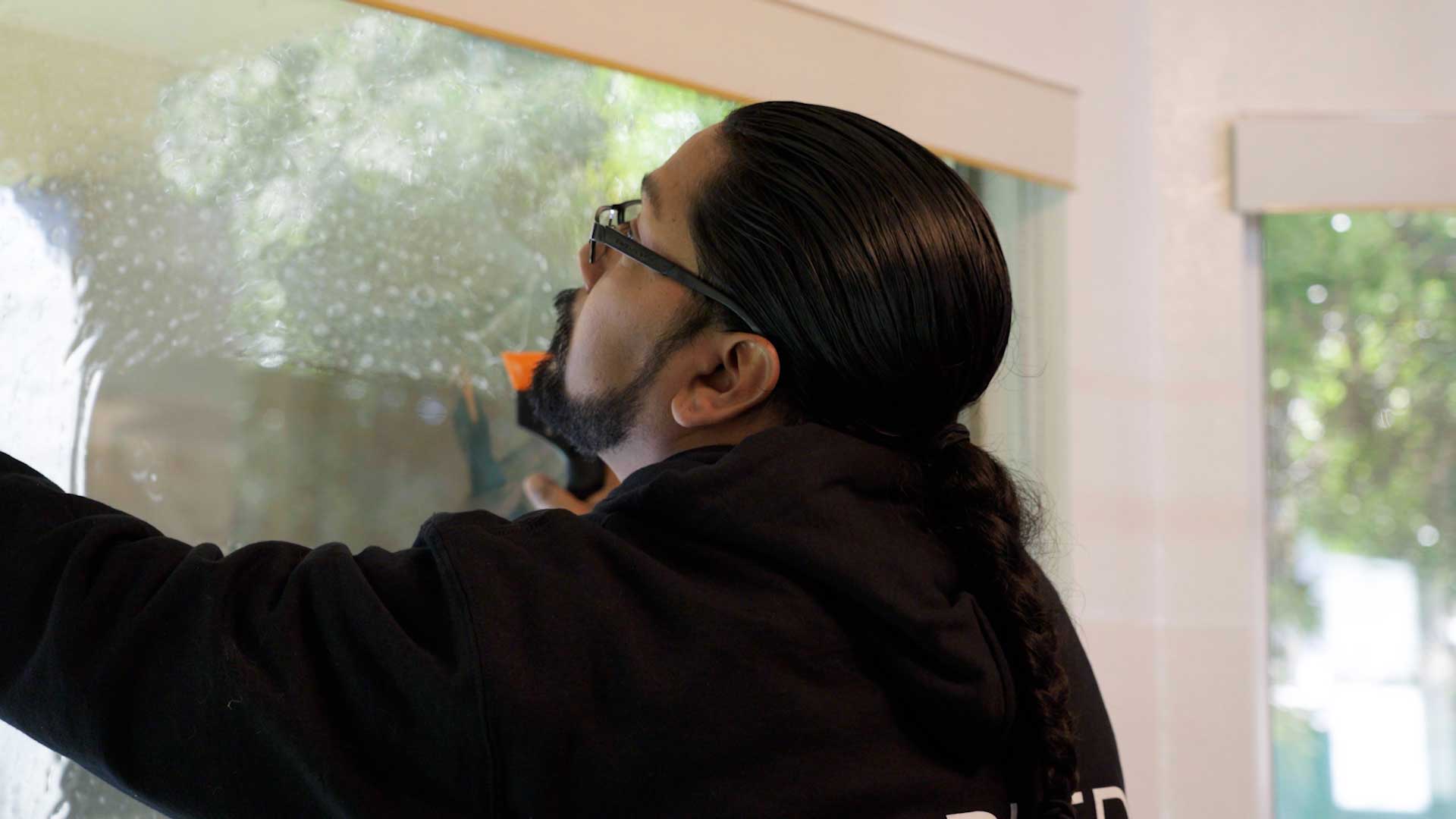 Kepler Installer Applying Security Window Film to a Building in New Mexico