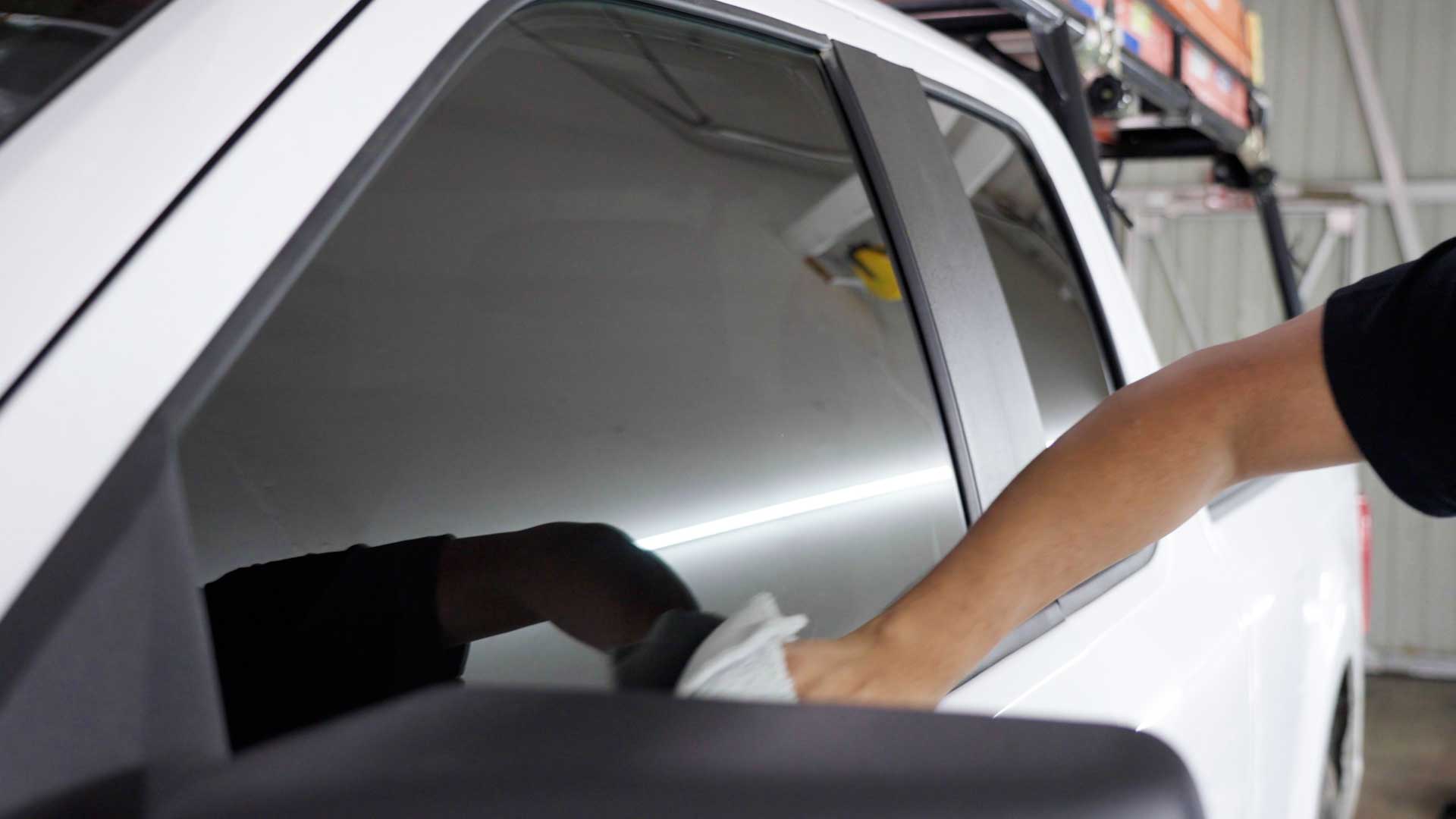Skilled Electric Vehicle Glass Tinting being cleaned after tinting in Naples