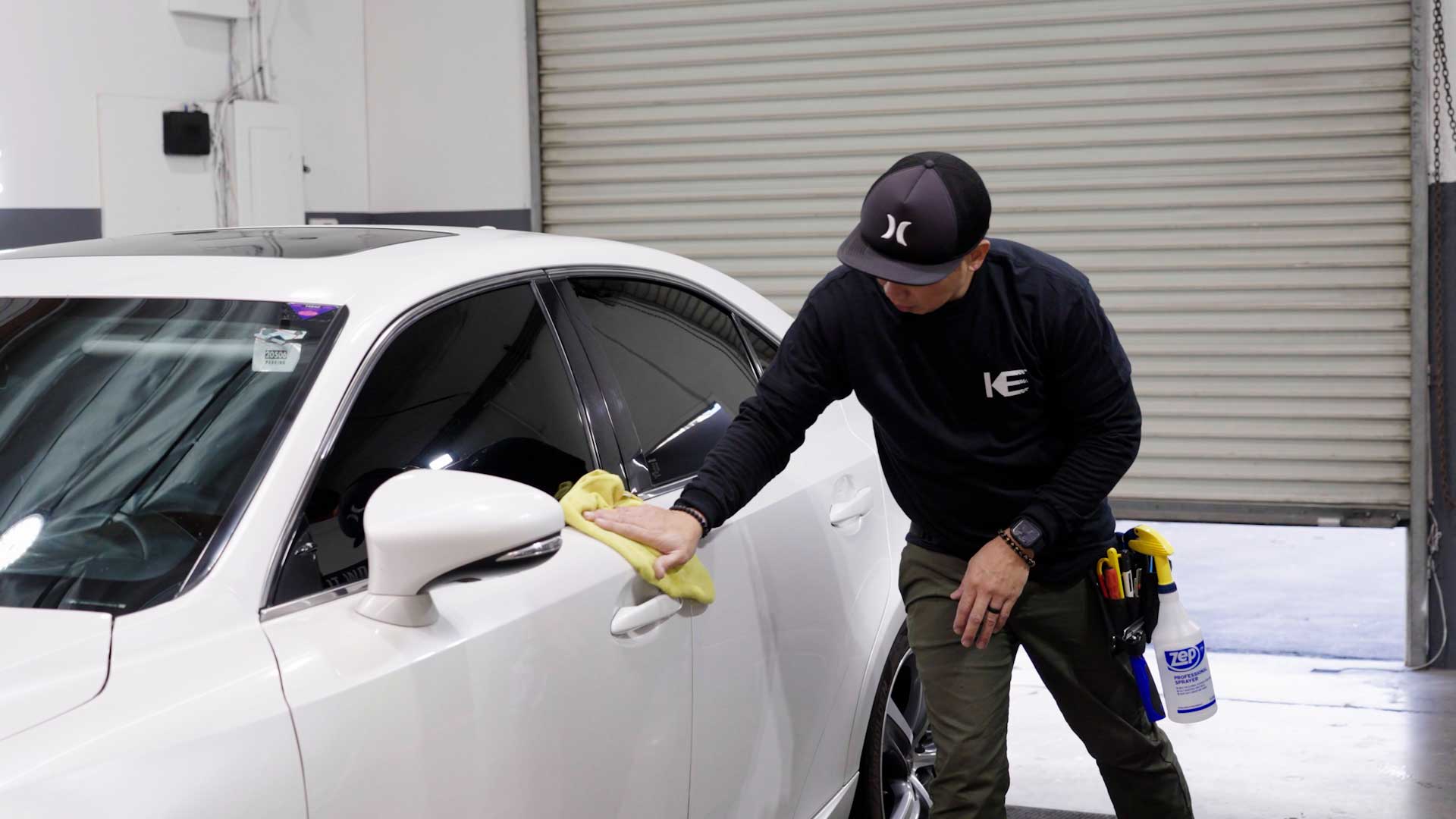 Skilled Tesla Window Tint being cleaned after tinting in Flint