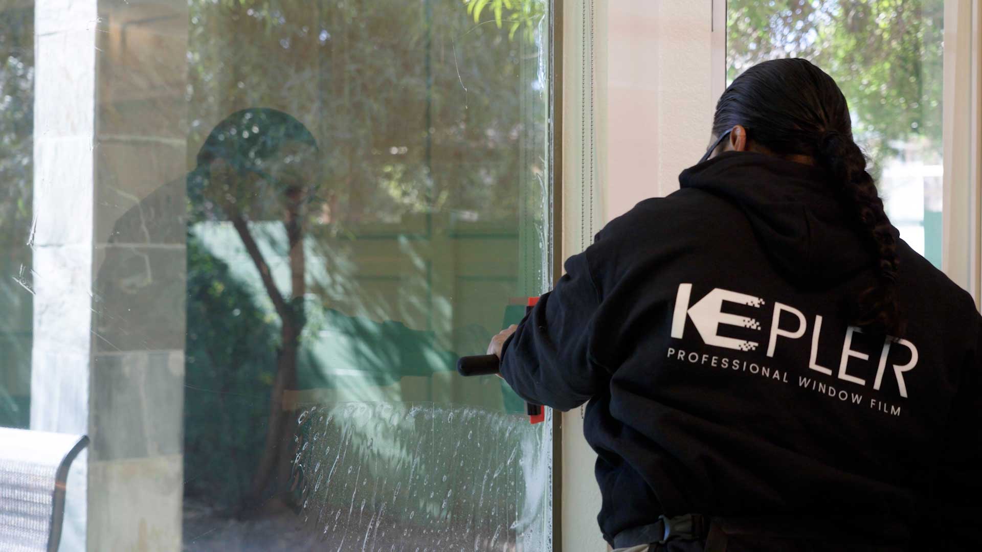 Kepler Installer Applying Security Window Film to a Building in Oklahoma