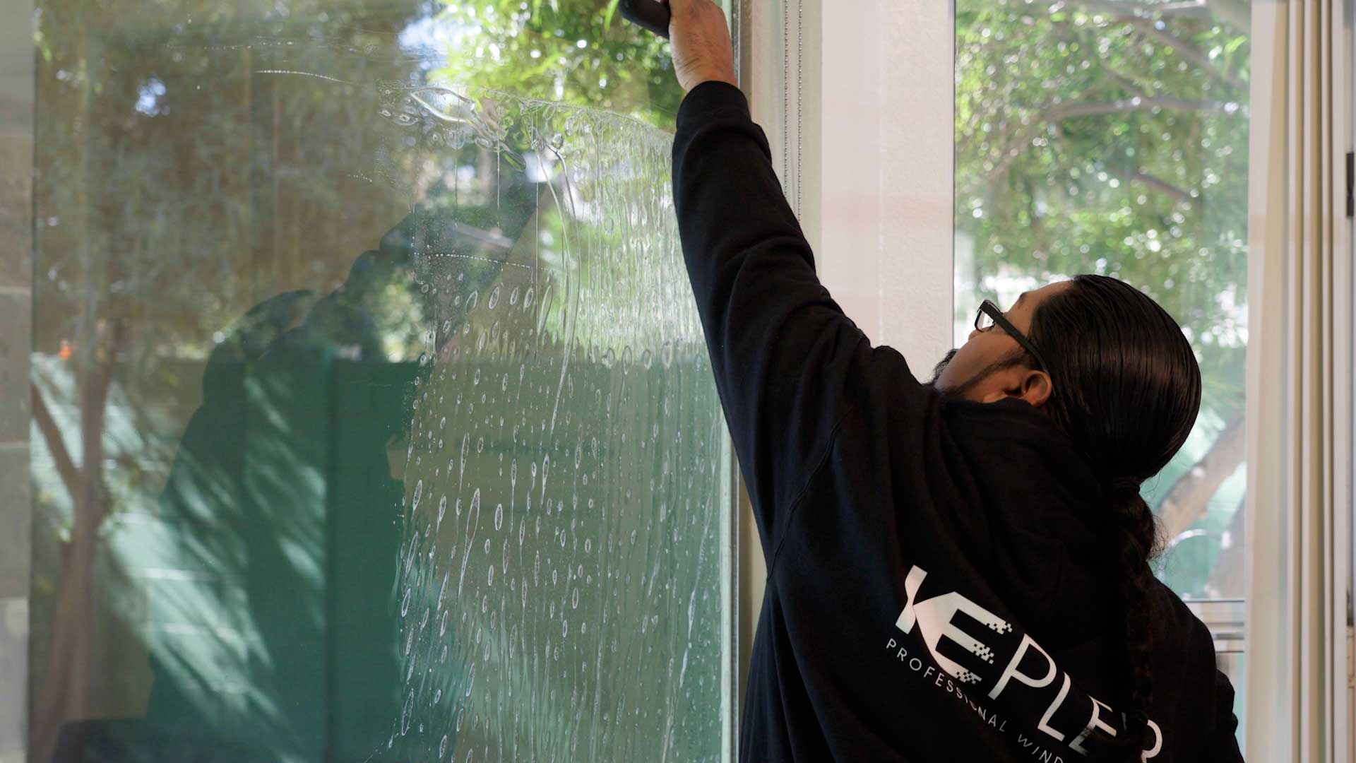 Kepler Installer Applying Security Window Film to a Building in Texas