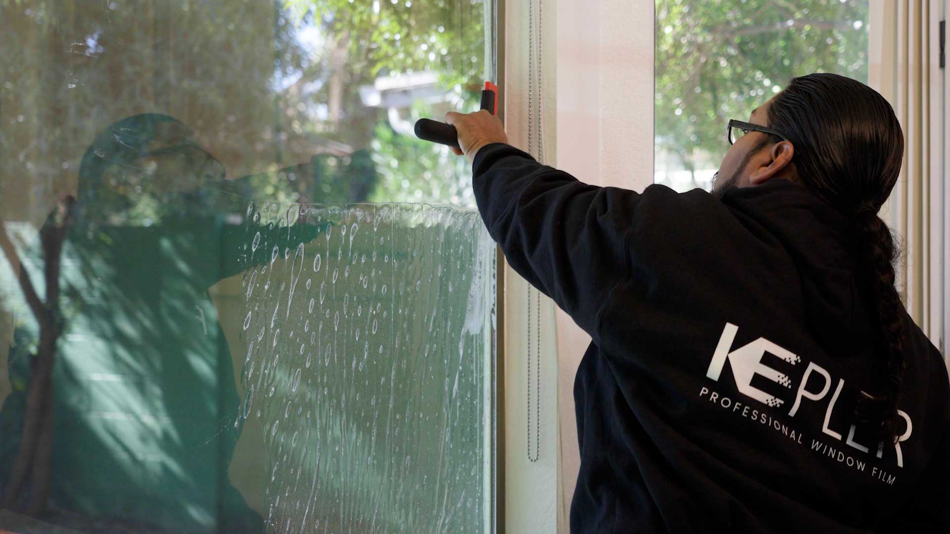Kepler Installer Applying Security Window Film to a Building in Washington
