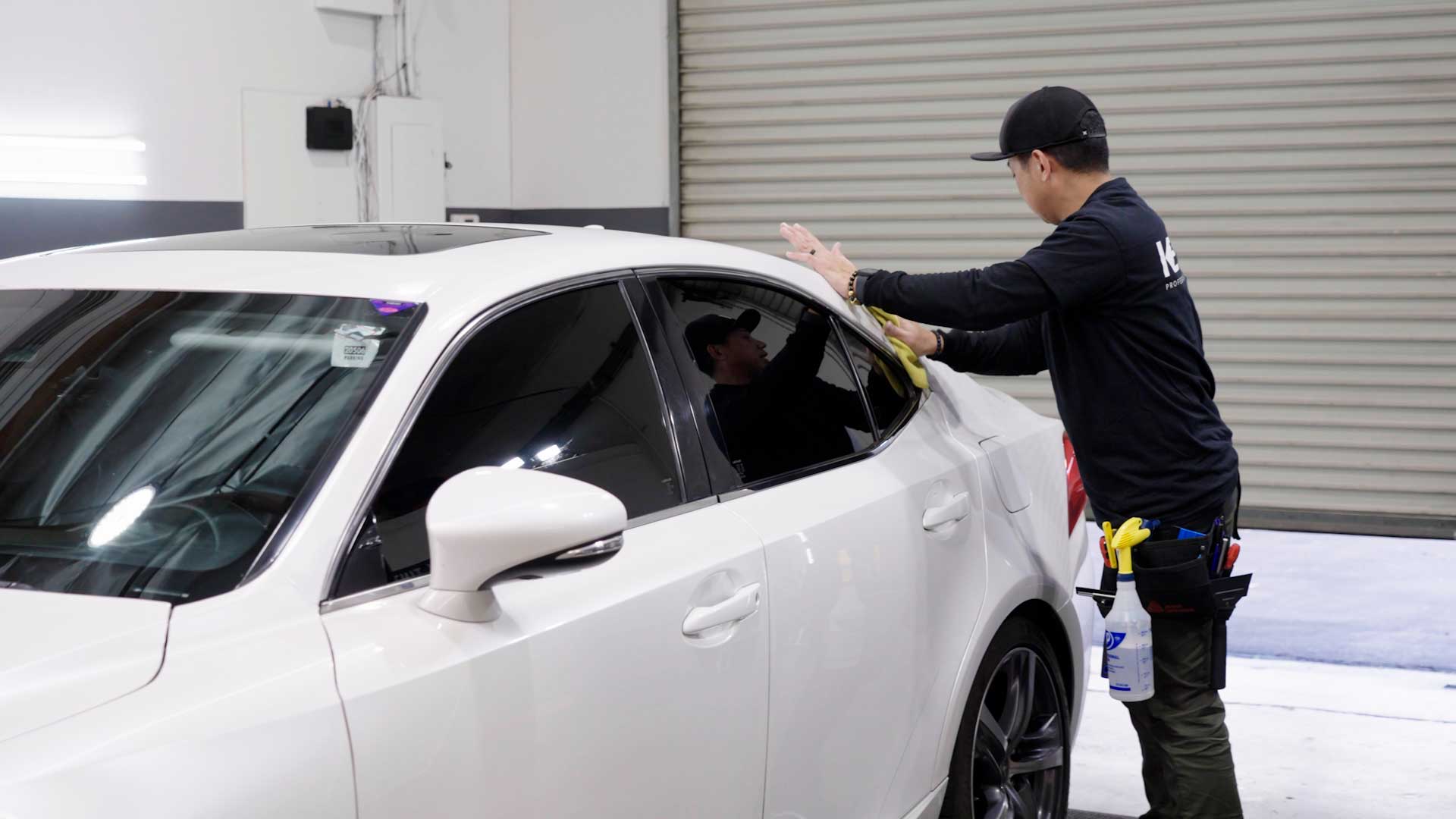 Skilled Electric Vehicle Glass Tinting being cleaned after tinting in Gresham