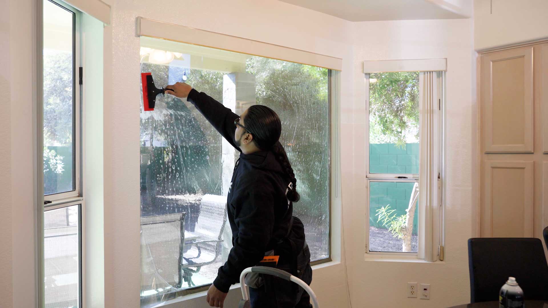 Kepler Installer Applying Security Window Film to a Building in Oregon