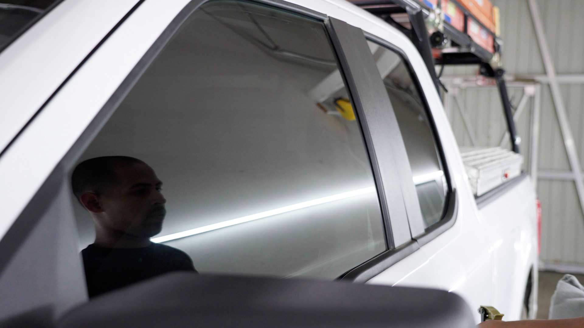 Skilled Electric Vehicle Glass Tint being cleaned after tinting in Edgewood