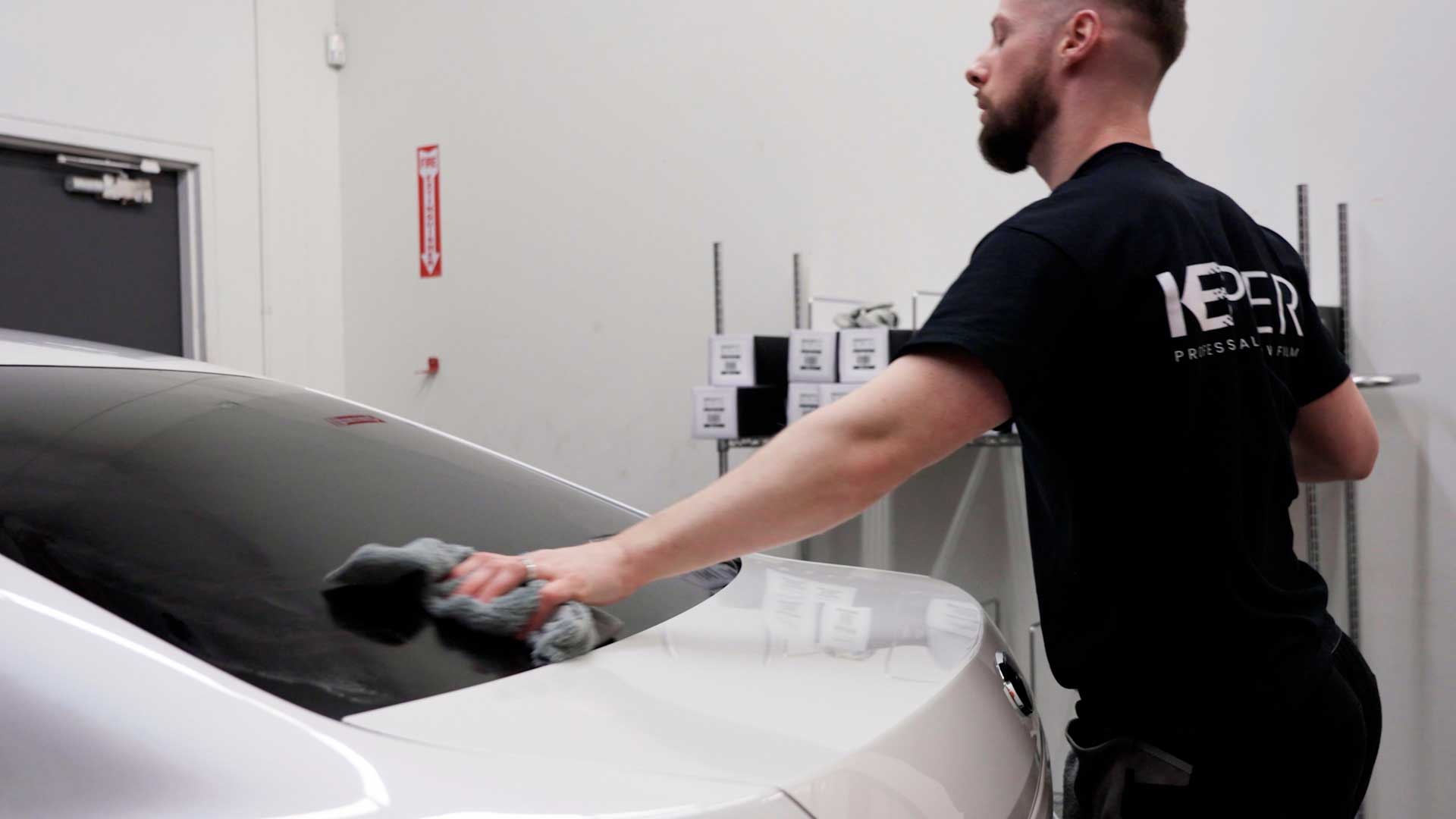 Skilled Electric Vehicle Window Tinting being cleaned after tinting in Kalamazoo